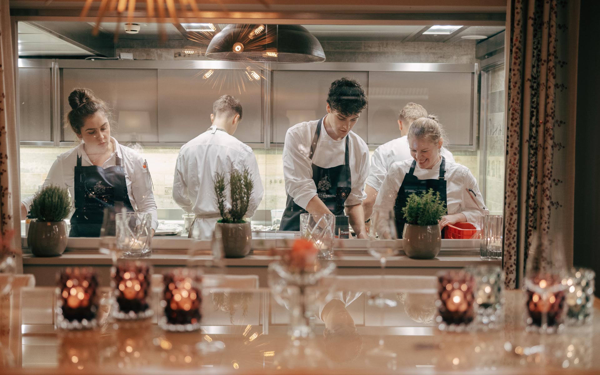 A glimpse into the kitchen through the window at Restaurant Haerlin***