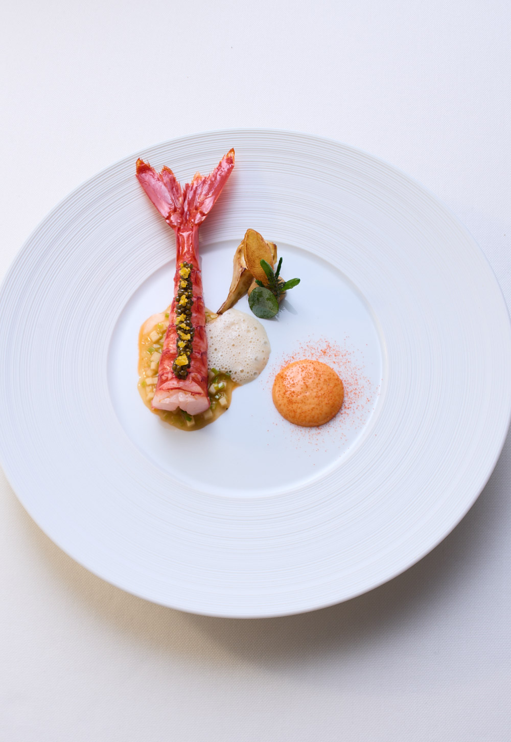 Artfully prepared carabinero on a flat plate