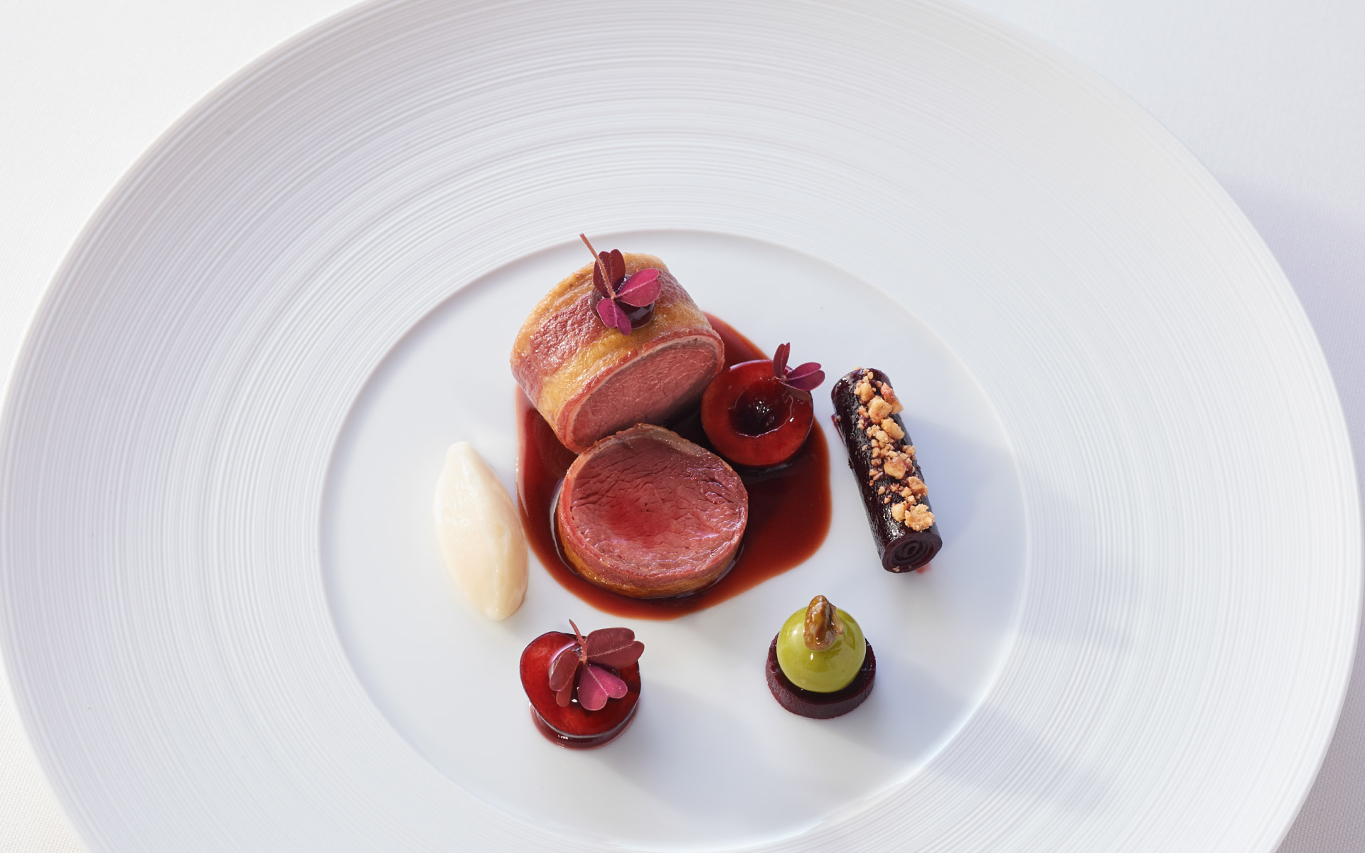 Artfully arranged venison on a flat plate